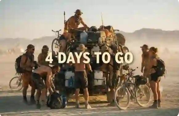 Diverse group of Burning Man participants preparing gear and checking maps beside a desert vehicle four days before the 2026 event opens