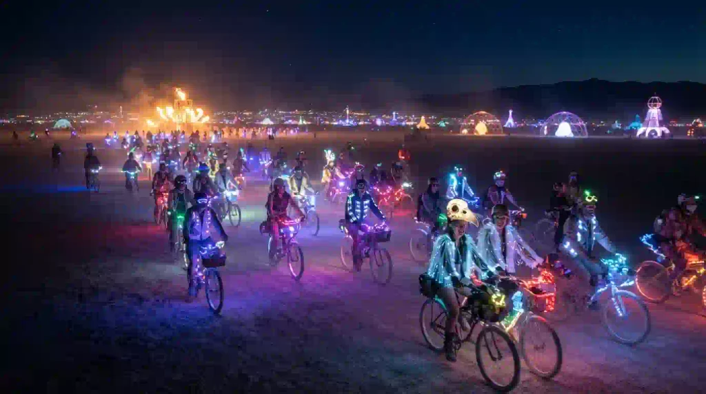Decorated bicycles with colorful lights at night in Black Rock City during Burning Man